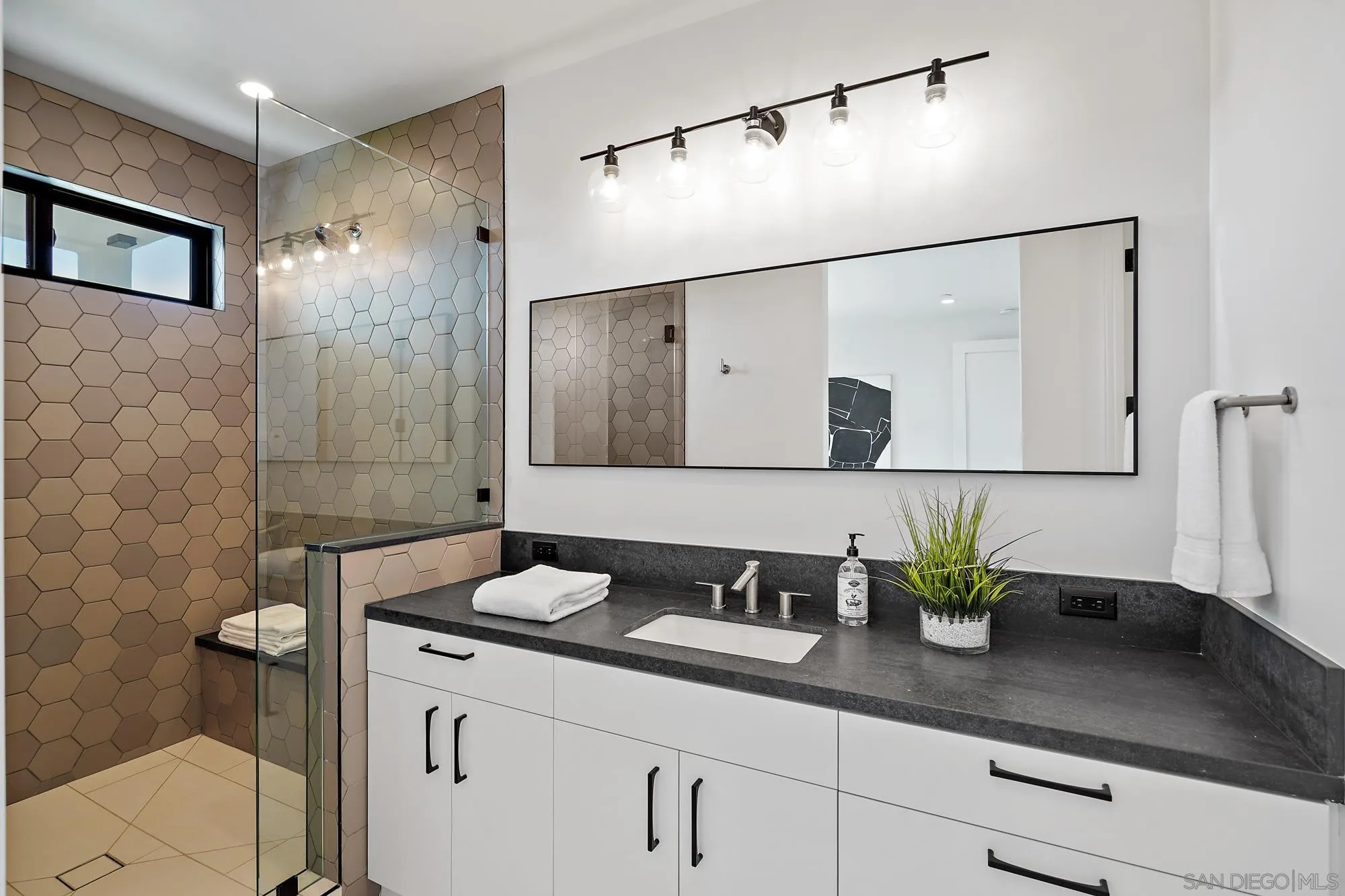 1604 Legaye Drive Cardiff, CA 92007 - Photo 27 of 42 a bathroom with a granite countertop sink a mirror and shower