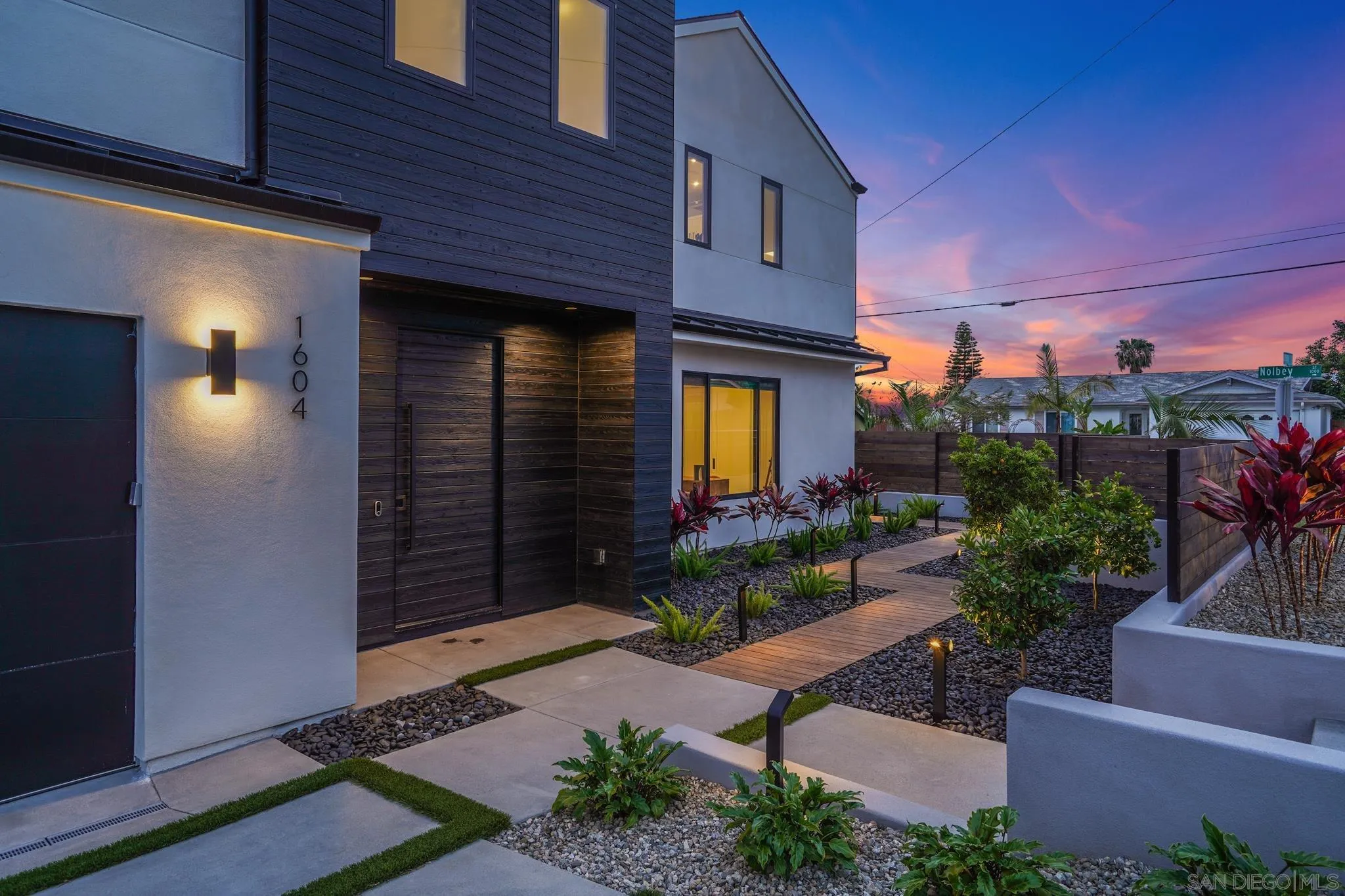 1604 Legaye Drive Cardiff, CA 92007 - Photo 38 of 42 a view of a house with potted plants and a bench