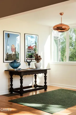 a living room with furniture a large window and a flat screen tv