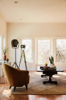 a living room with furniture floor to ceiling window and a floor to ceiling window