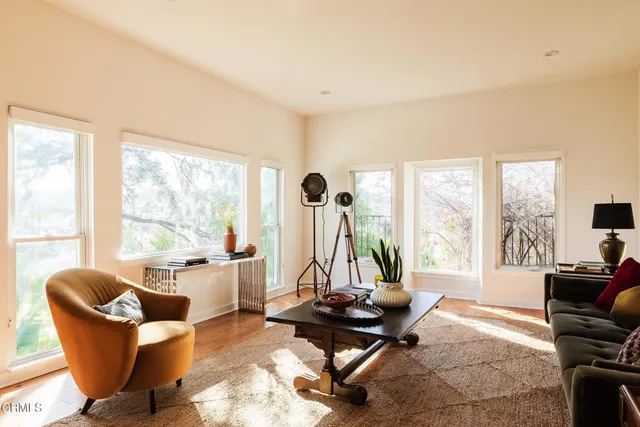 a living room with furniture a rug floor and a fireplace