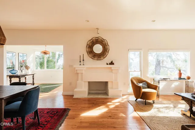 a living room with furniture a dining table and a chandelier