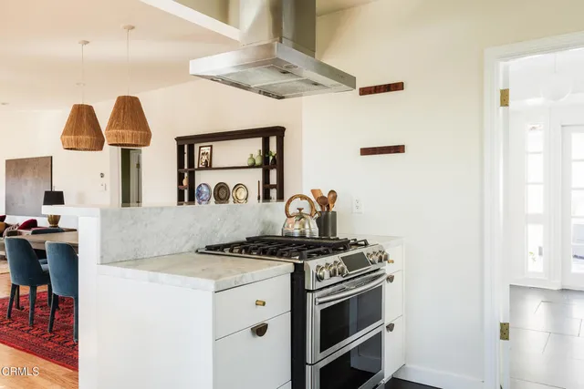 a kitchen with stainless steel appliances granite countertop a sink and a stove