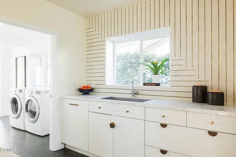 a kitchen with appliances cabinets and a window
