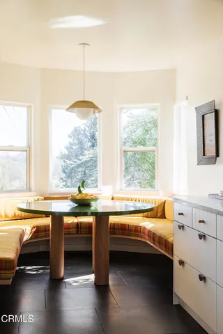 a kitchen with stainless steel appliances white cabinets and wooden floor