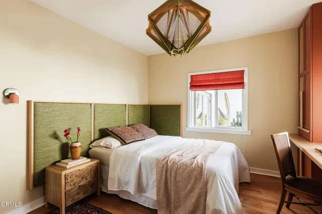 a bedroom with a bed and a chandelier