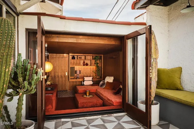 a living room with furniture a chandelier and a large window