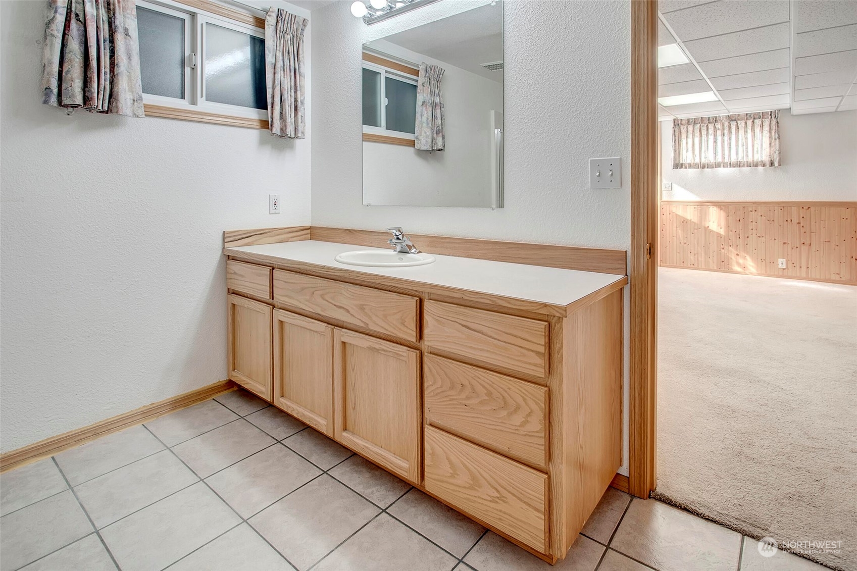 4604 Southwest Wildwood Place Seattle, WA 98136 - Photo 23 of 32 a bathroom with a sink vanity and a mirror