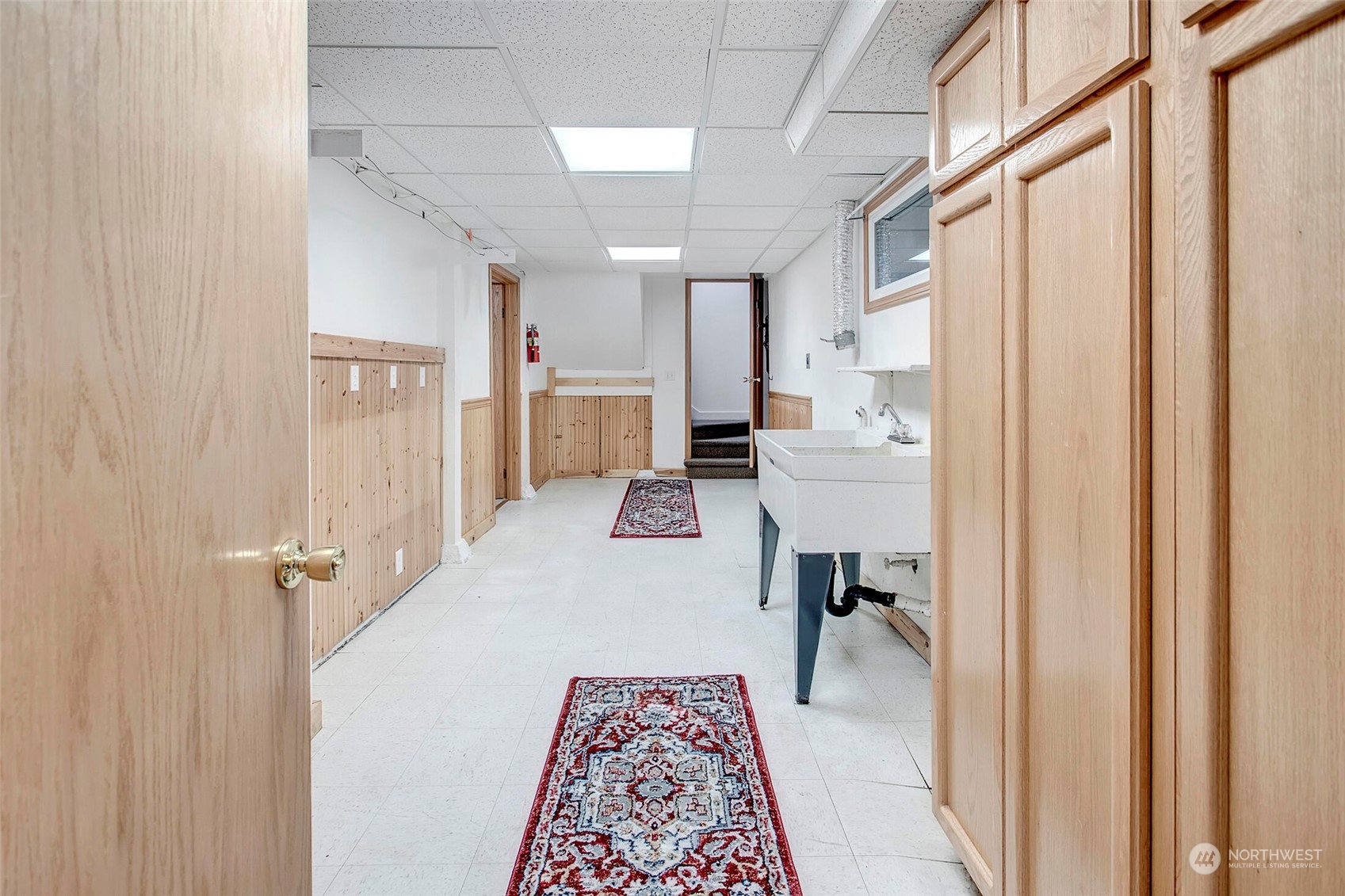 4604 Southwest Wildwood Place Seattle, WA 98136 - Photo 28 of 32 a hallway with a white cabinets and wooden floor