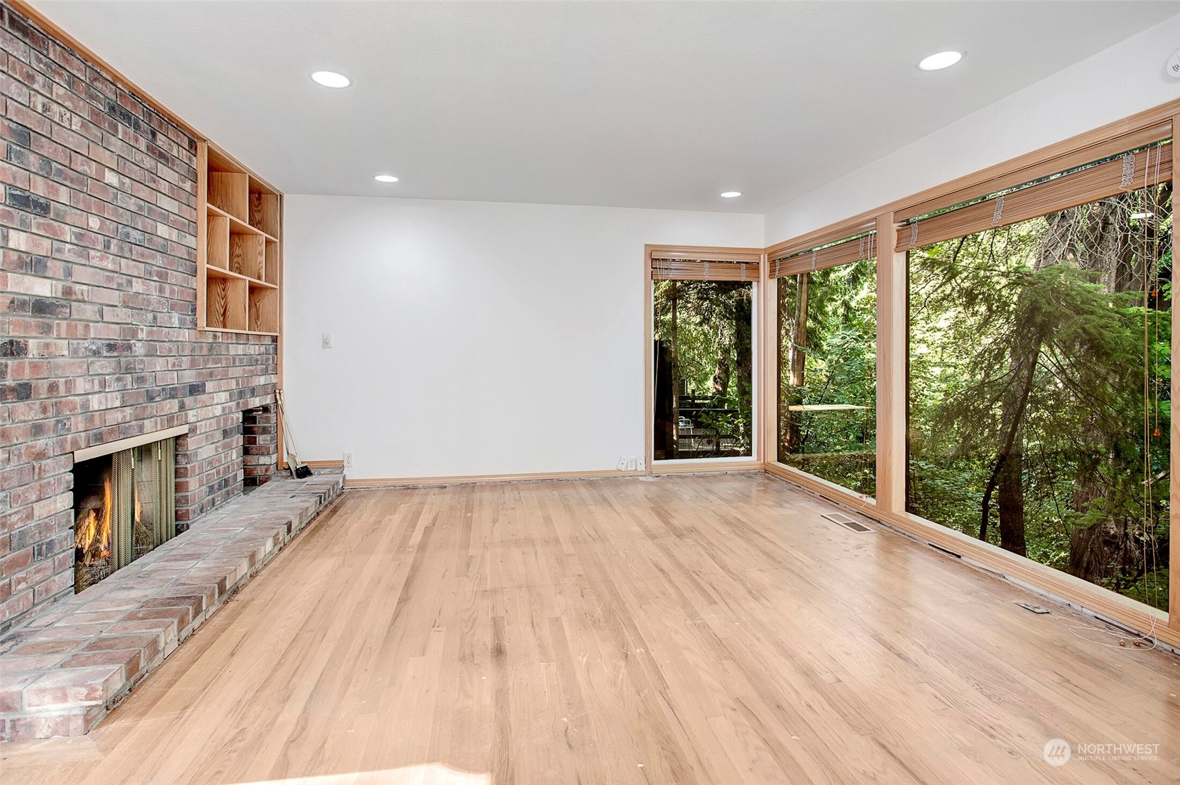 4604 Southwest Wildwood Place Seattle, WA 98136 - Photo 5 of 32 a view of an empty room with a fireplace and a window