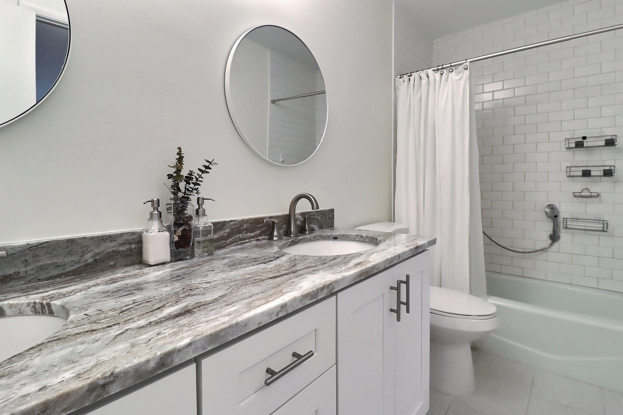 1330 High Point Place North, Unit C Delray Beach, FL 33445 - Photo 13 of 20 a bathroom with a granite countertop sink a toilet and a mirror