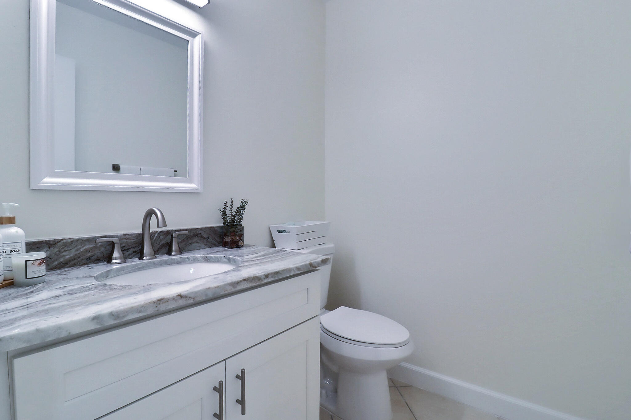 1330 High Point Place North, Unit C Delray Beach, FL 33445 - Photo 14 of 20 a bathroom with a granite countertop sink and a toilet