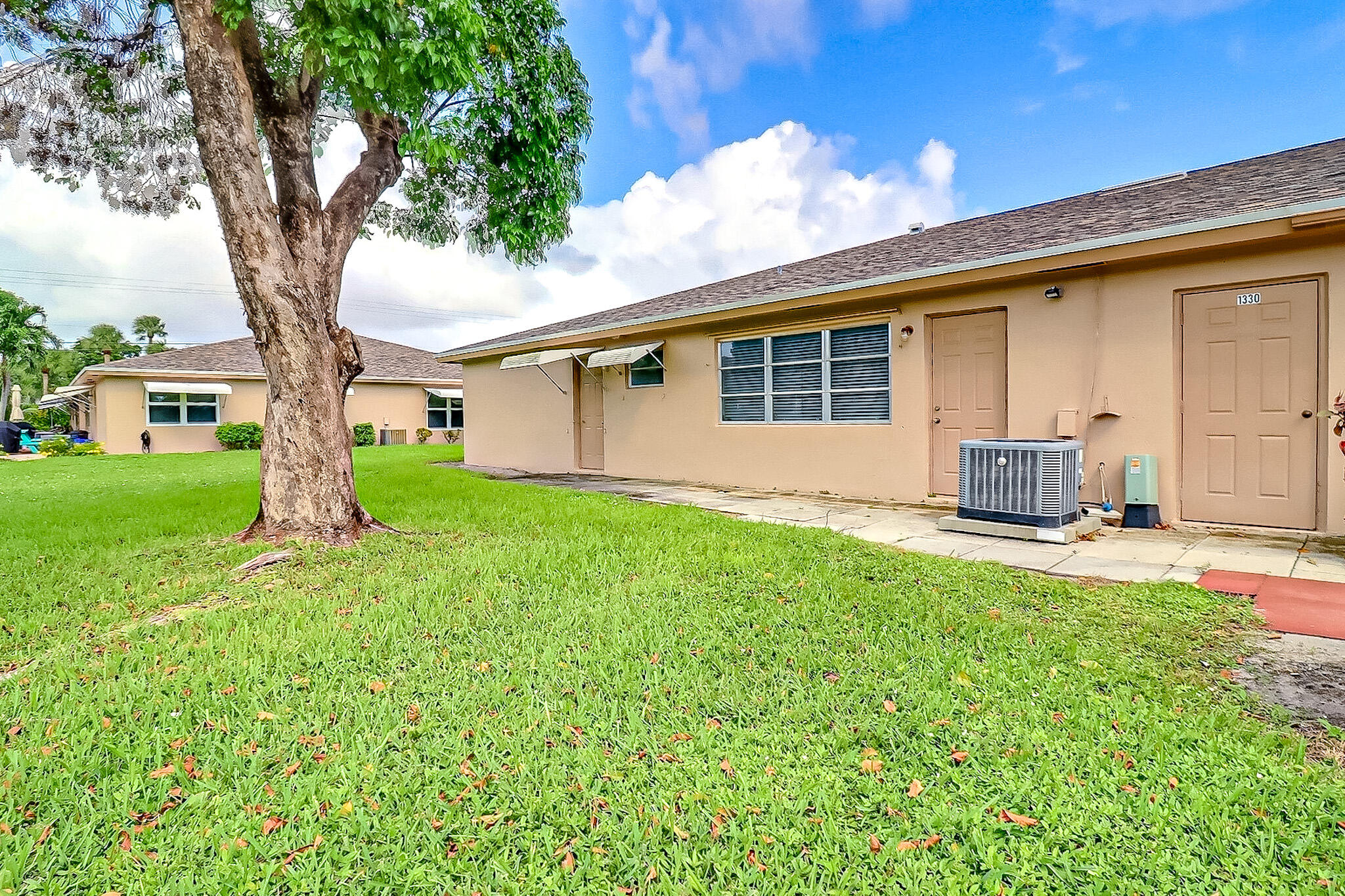 1330 High Point Place North, Unit C Delray Beach, FL 33445 - Photo 17 of 20 a front view of house with yard and green space