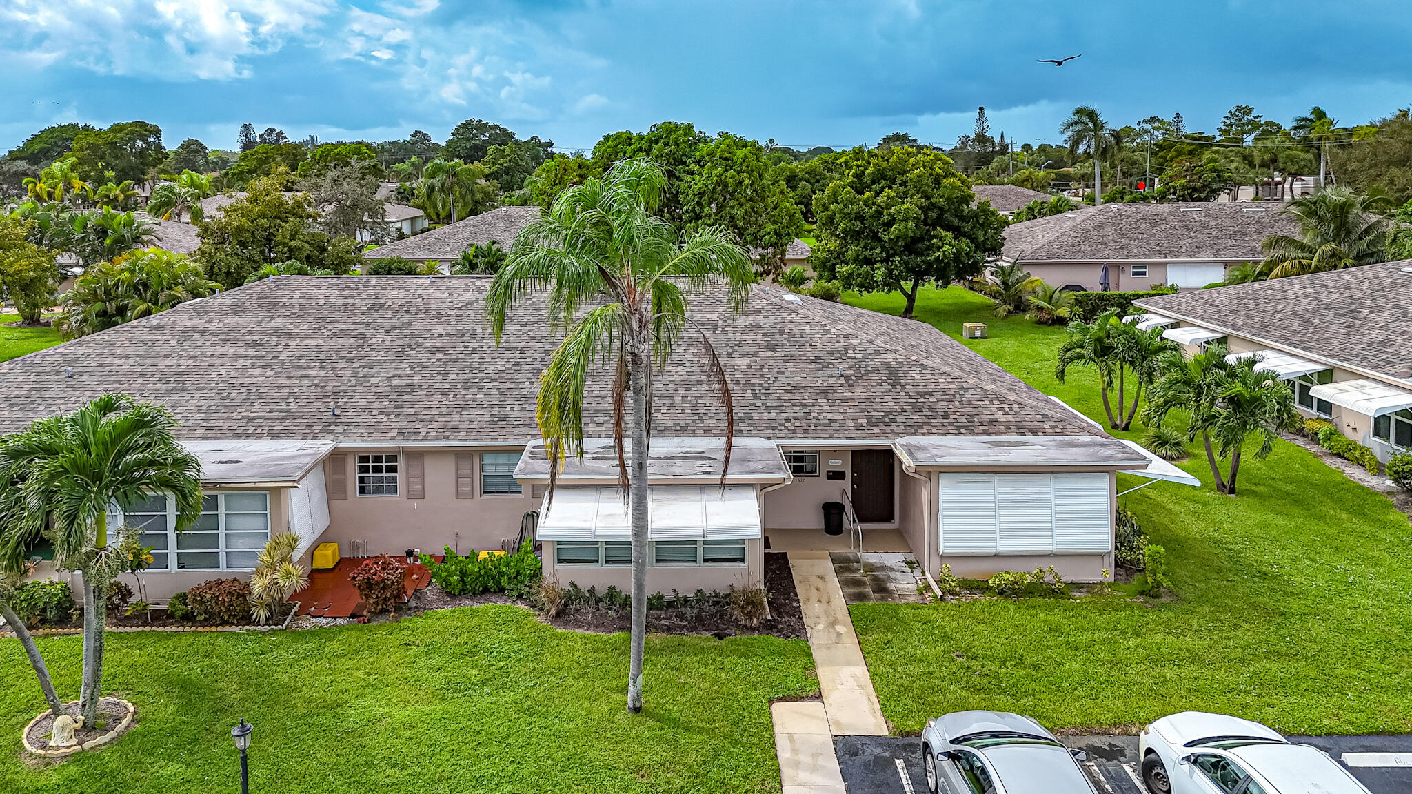 1330 High Point Place North, Unit C Delray Beach, FL 33445 - Photo 20 of 20 a aerial view of a house next to a big yard and large trees