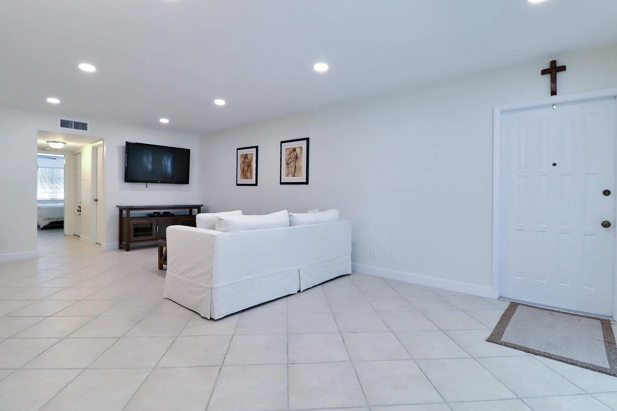 1330 High Point Place North, Unit C Delray Beach, FL 33445 - Photo 10 of 20 a living room with furniture and a flat screen tv