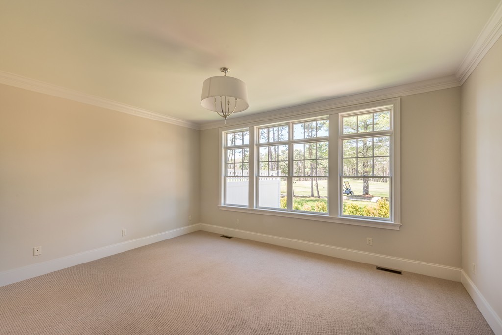 40 Clayton Circle, Unit B Mashpee, MA 02649 - Photo 8 of 12 an empty room with a empty space and windows