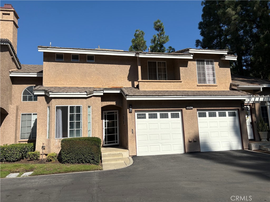 11254 Terra Vista Parkway Rancho Cucamonga, CA 91730 - Photo 1 of 18 a front view of a house with a garage