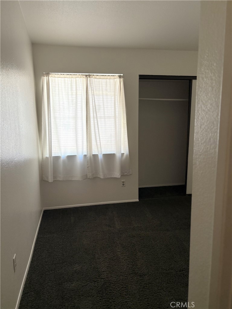11254 Terra Vista Parkway Rancho Cucamonga, CA 91730 - Photo 12 of 18 an empty room with wooden floor and windows