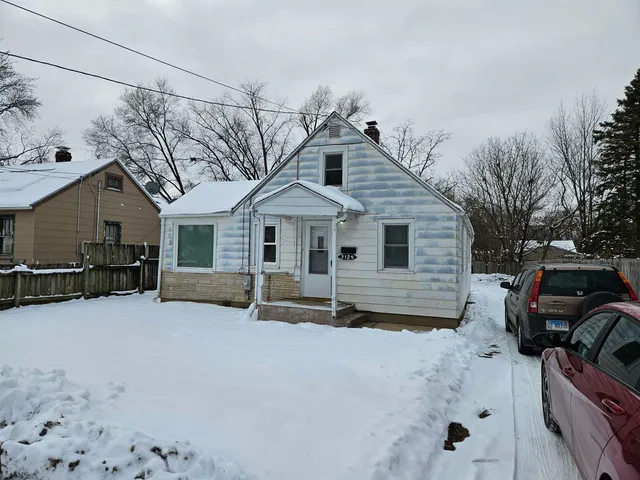 a view of a house with a yard covered in snow