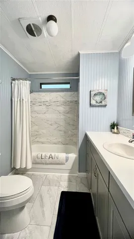 a spacious bathroom with a granite countertop sink mirror and a bathtub