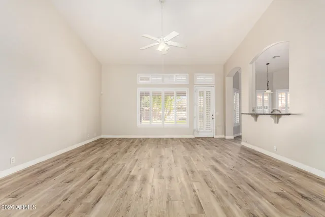 wooden floor in an empty room with a window