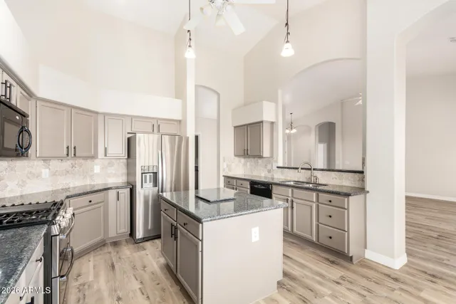 a kitchen with a sink stove and refrigerator