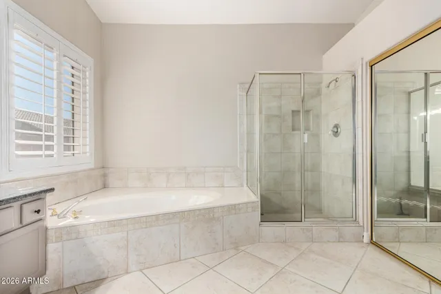 a bathroom with a bathtub and shower