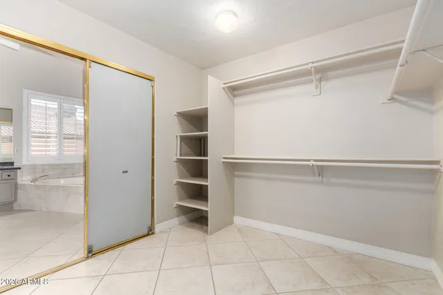 a view of walk in closet with empty racks