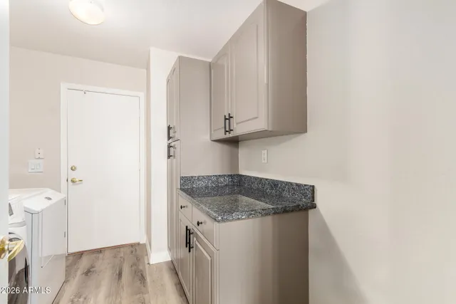 a utility room with sink dryer and washer