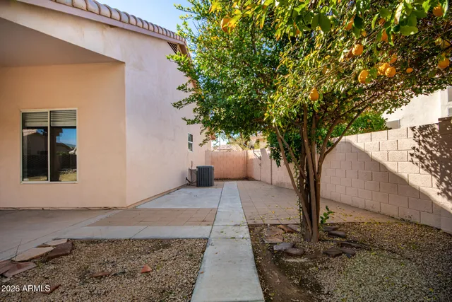 a white house that has a tree in front of it