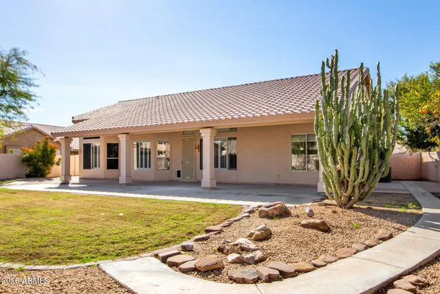 a view of a house with swimming pool and sitting area