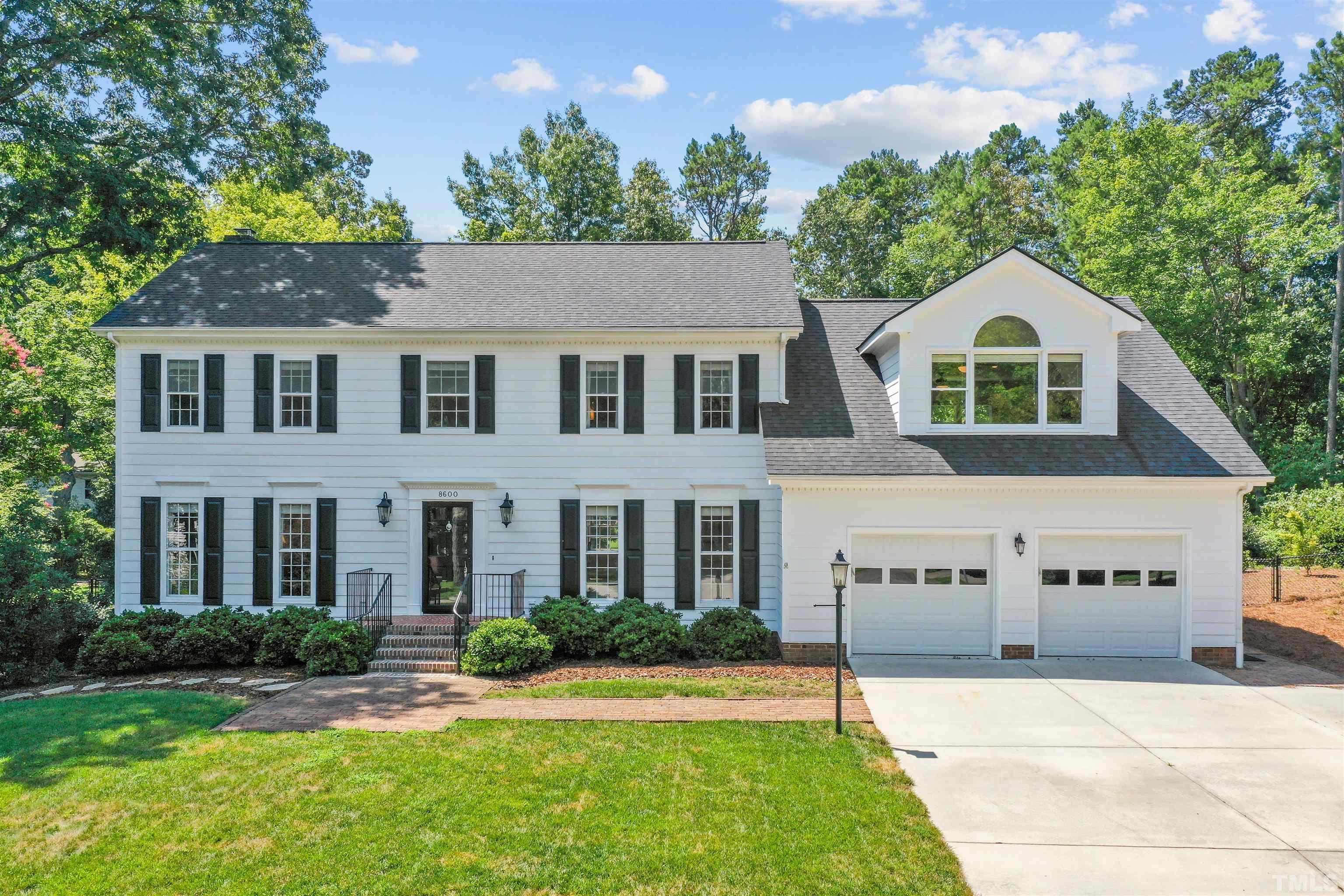 8600 Timberwind Drive Raleigh, NC 27615 - Photo 1 of 46 a front view of a house with a yard