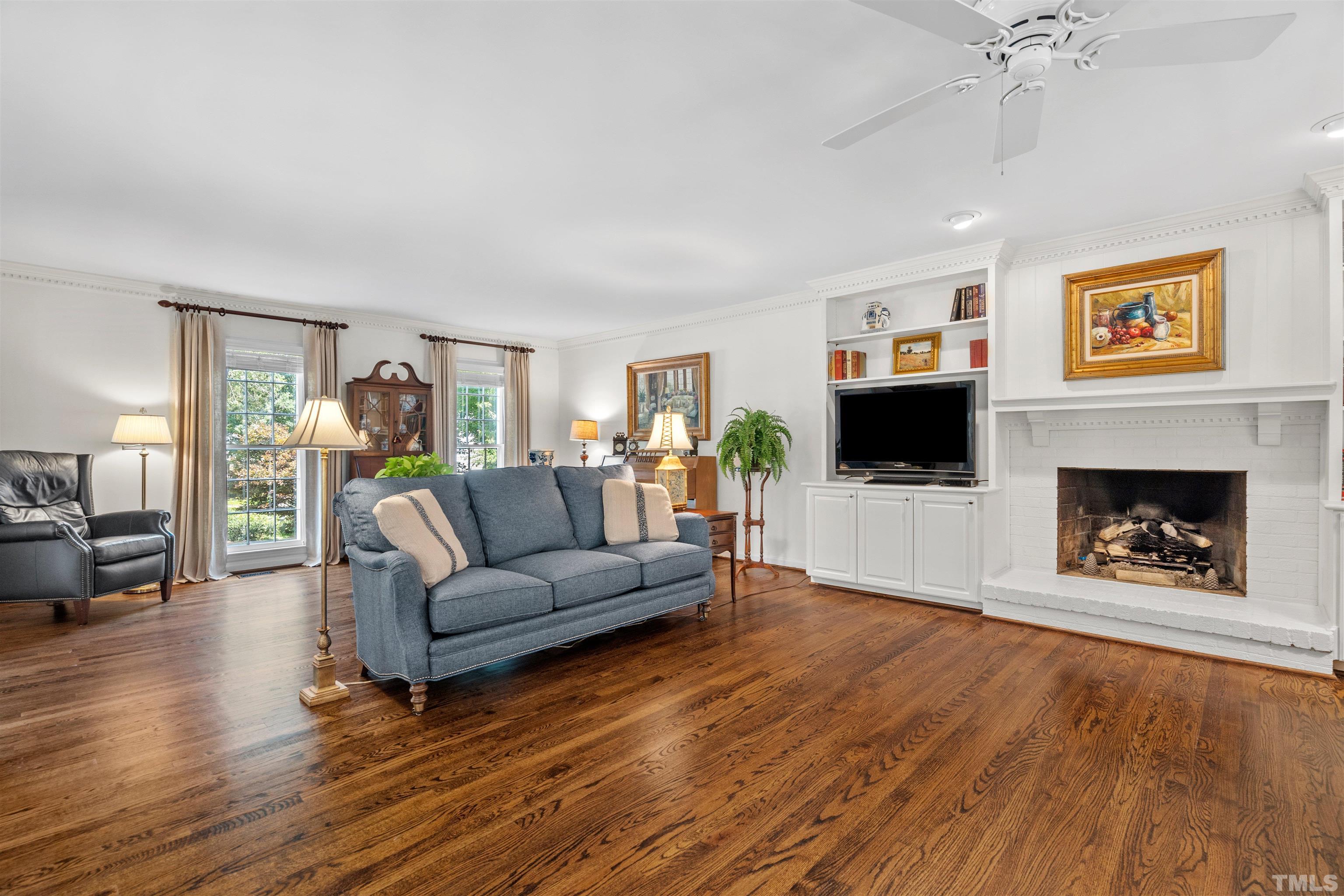 8600 Timberwind Drive Raleigh, NC 27615 - Photo 13 of 46 a living room with furniture and a fireplace