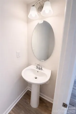 a bathroom with a sink vanity and toilet