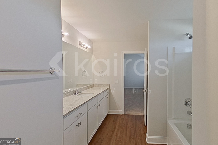 103 Western Red Cedar Drive Springfield, GA 31329 - Photo 17 of 24 a spacious bathroom with a granite countertop sink mirror and a shower