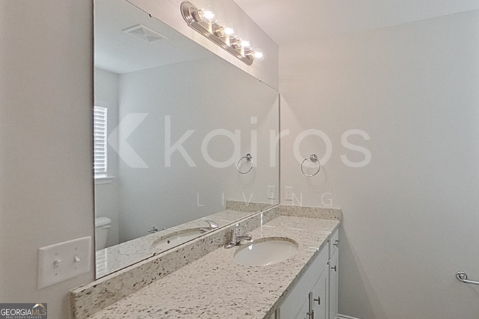 103 Western Red Cedar Drive Springfield, GA 31329 - Photo 18 of 24 a bathroom with a granite countertop sink a mirror and shower