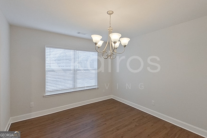 103 Western Red Cedar Drive Springfield, GA 31329 - Photo 4 of 24 a view of a room with wooden floor chandelier and windows
