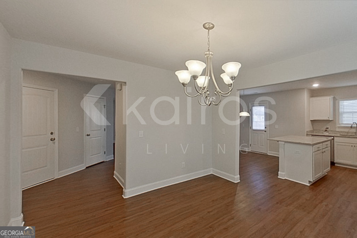 103 Western Red Cedar Drive Springfield, GA 31329 - Photo 5 of 24 a view of a room with wooden floor and chandelier