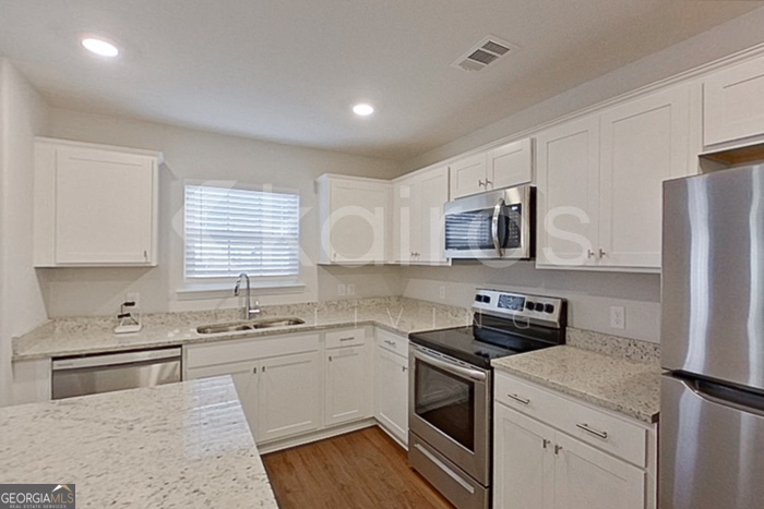 103 Western Red Cedar Drive Springfield, GA 31329 - Photo 6 of 24 a kitchen with a sink stove top oven and refrigerator