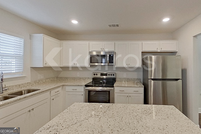 103 Western Red Cedar Drive Springfield, GA 31329 - Photo 7 of 24 a kitchen with a refrigerator sink and cabinets
