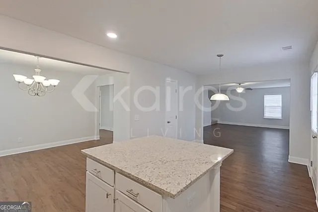 a kitchen with a sink cabinets and wooden floor