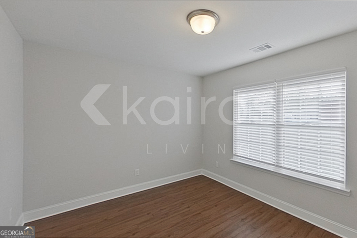 103 Western Red Cedar Drive Springfield, GA 31329 - Photo 9 of 24 an empty room with wooden floor and windows