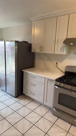 a kitchen with granite countertop cabinets and steel stainless steel appliances