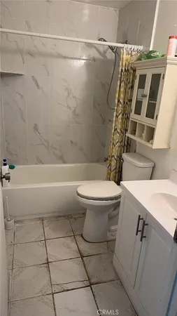 a bathroom with a toilet a sink and a shower