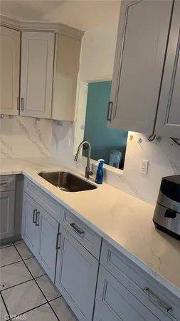 a kitchen with a sink and cabinets