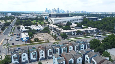 an aerial view of residential houses with a city view