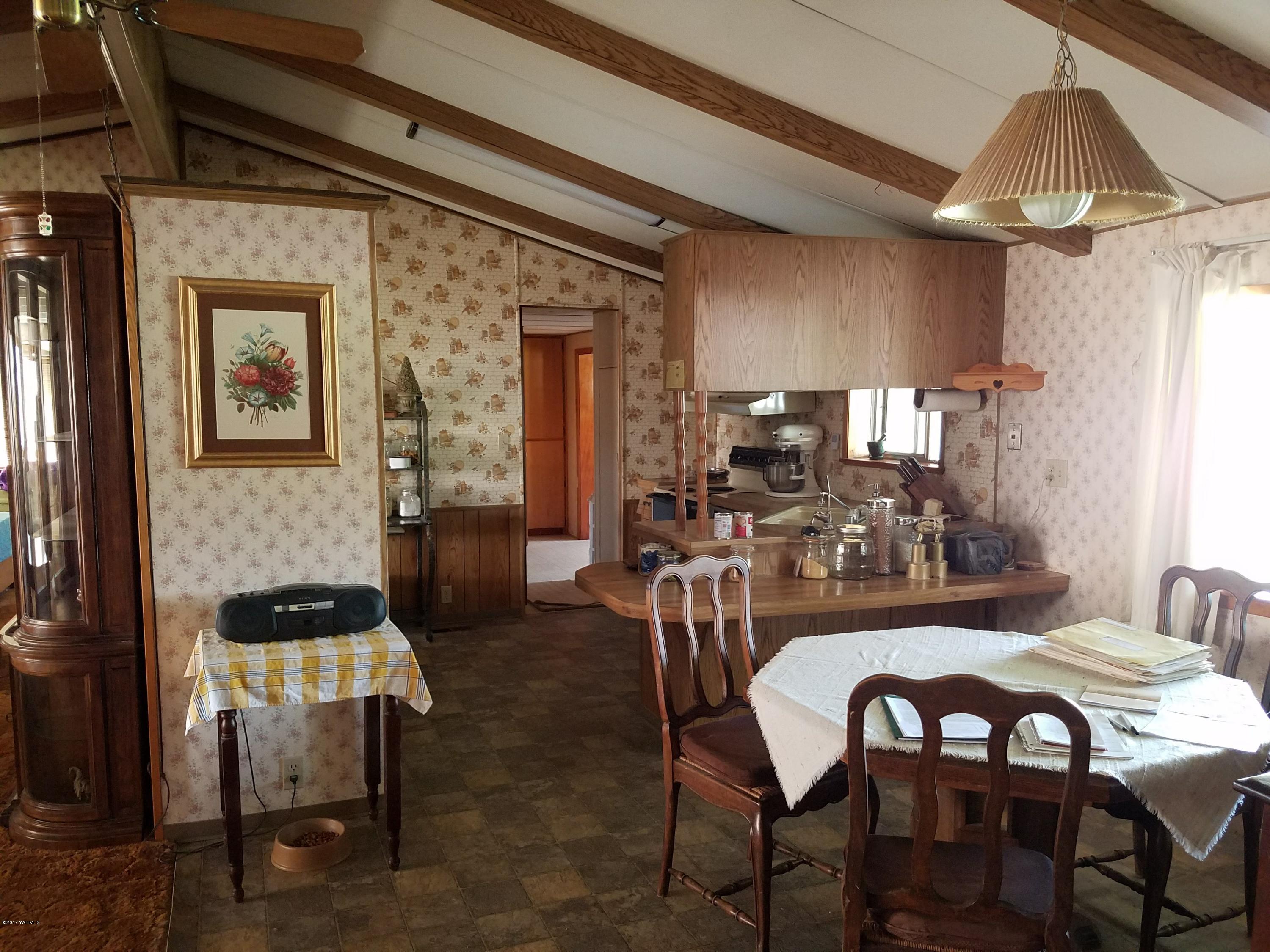 255 Prairie Road Moxee, WA 98936 - Photo 12 of 25 a view of a dining room with furniture and wooden floor
