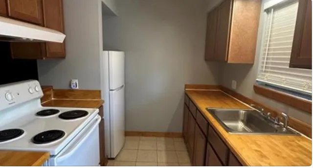 a kitchen with a stove and a refrigerator