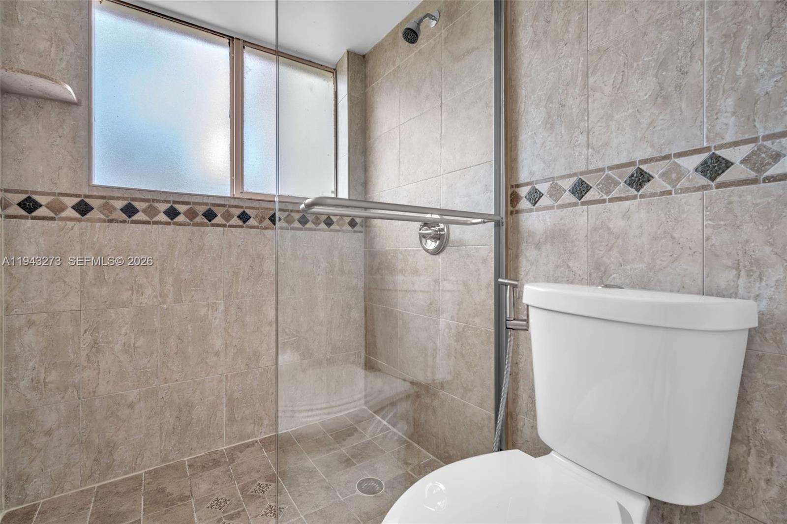 1618 Northwest 81st Way, Unit 1618 Plantation, FL 33322 - Photo 28 of 38 a white toilet sitting next to a shower