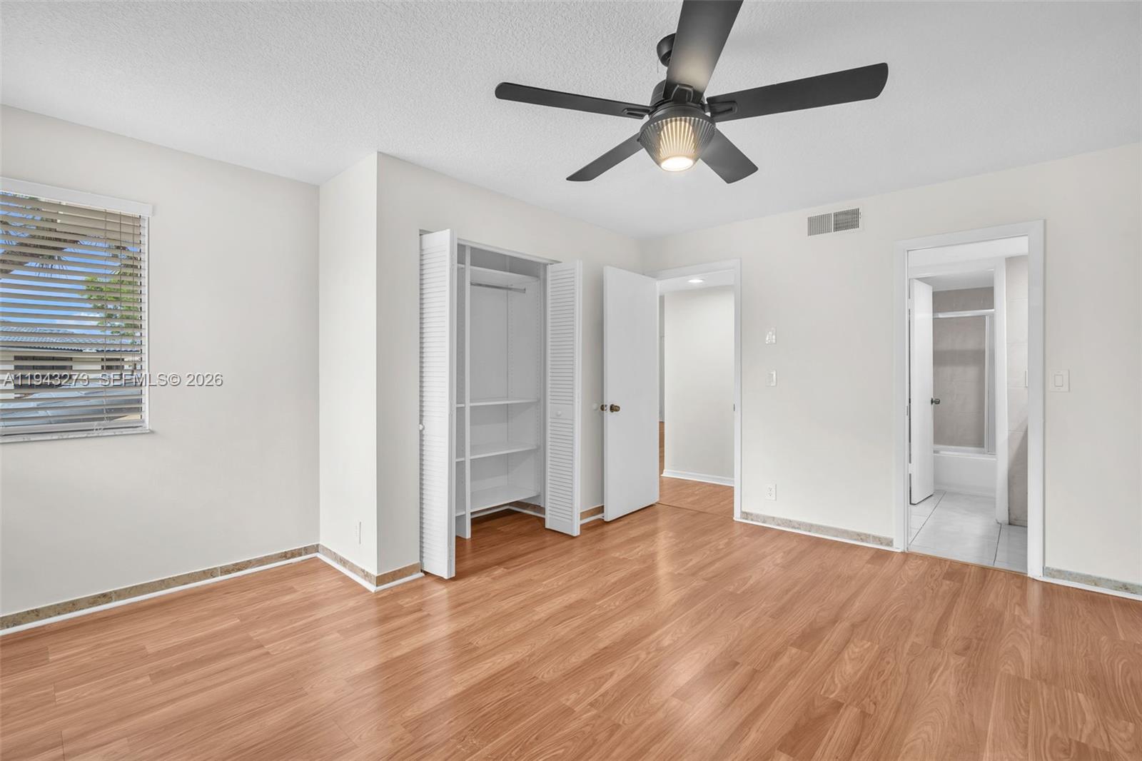 1618 Northwest 81st Way, Unit 1618 Plantation, FL 33322 - Photo 30 of 38 a view of empty room with wooden floor and fan